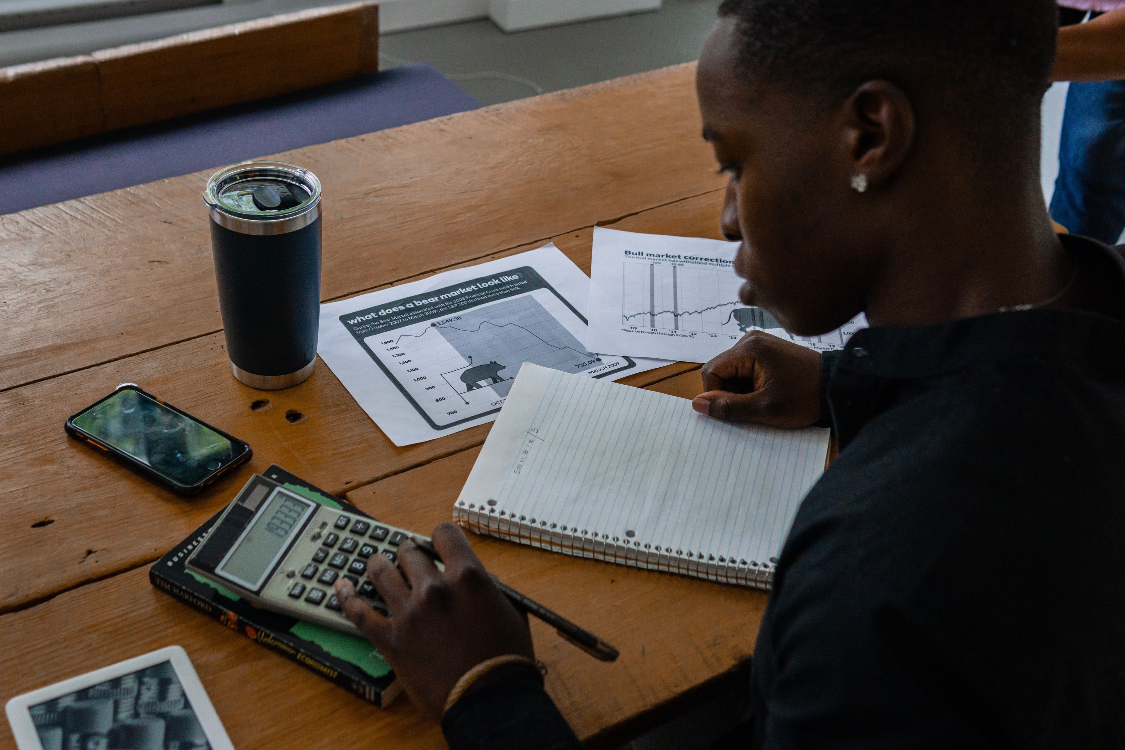 Financial analyst reviewing market data at a desk
