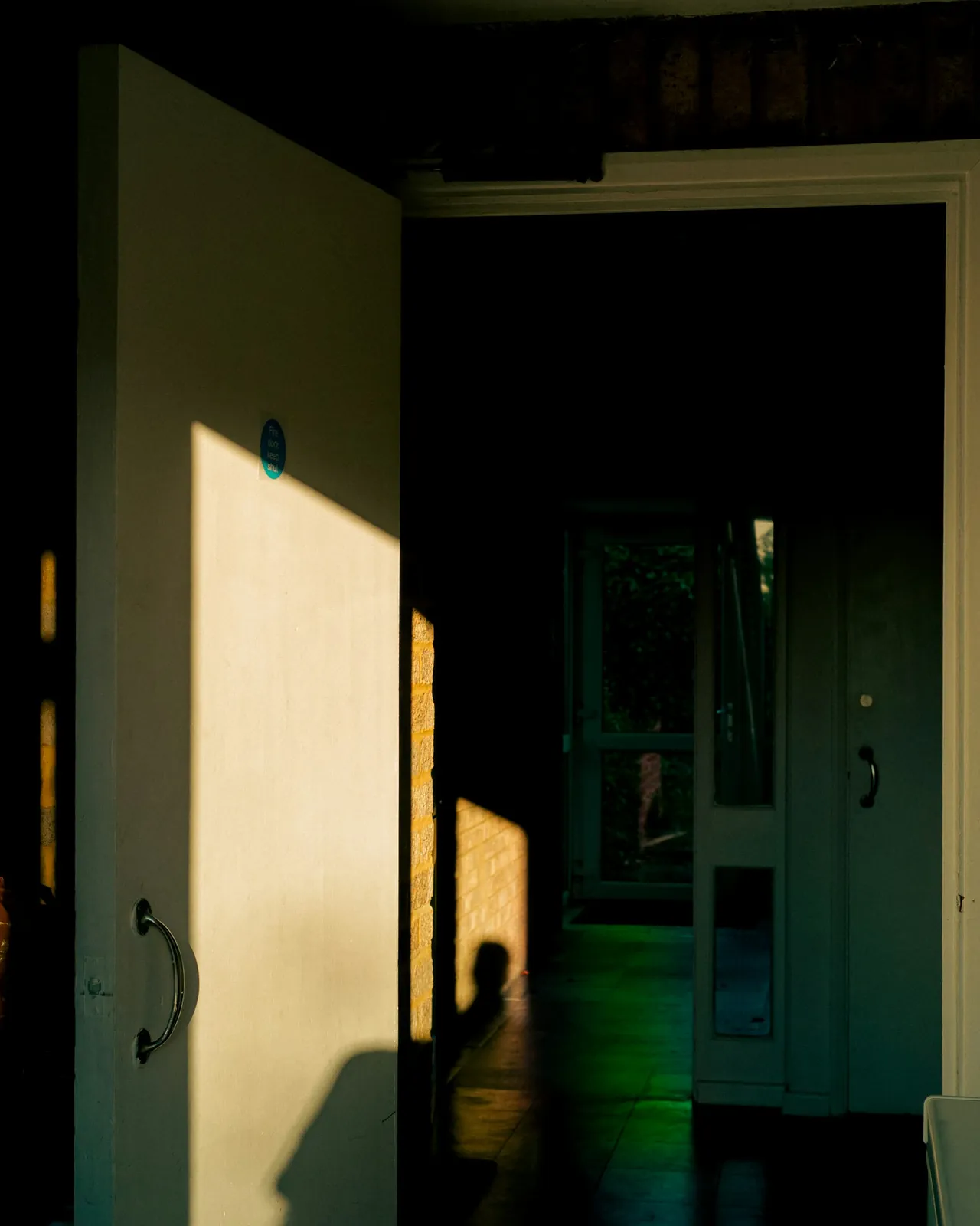 An open doorway shaped by warm light and shadow